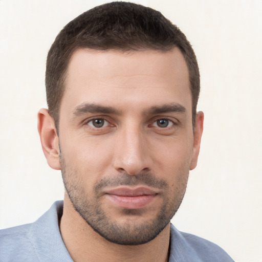 Joyful white young-adult male with short  brown hair and brown eyes