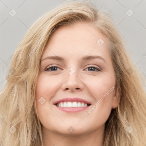 Joyful white young-adult female with long  brown hair and blue eyes