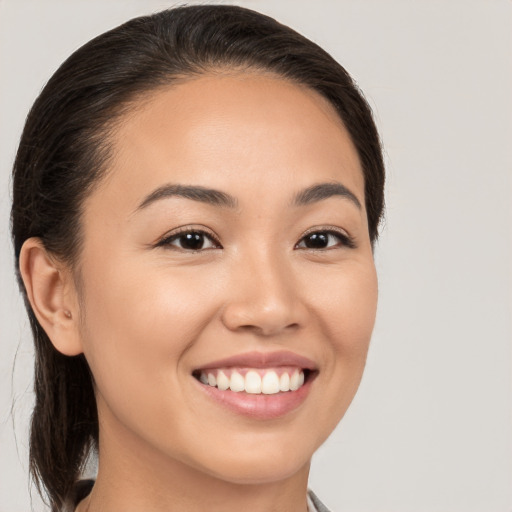 Joyful white young-adult female with medium  brown hair and brown eyes