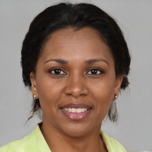 Joyful latino adult female with medium  brown hair and brown eyes