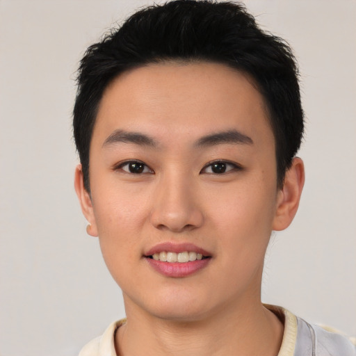 Joyful asian young-adult male with short  black hair and brown eyes