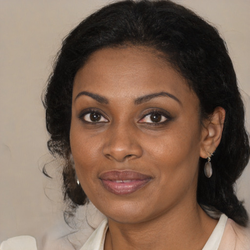 Joyful black adult female with medium  brown hair and brown eyes