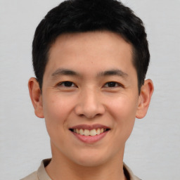 Joyful asian young-adult male with short  brown hair and brown eyes