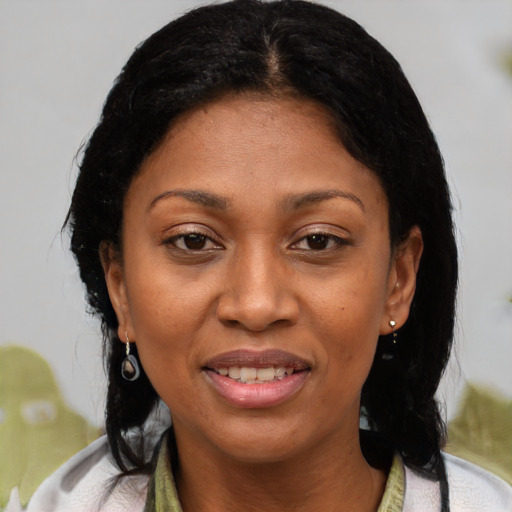 Joyful latino adult female with medium  brown hair and brown eyes