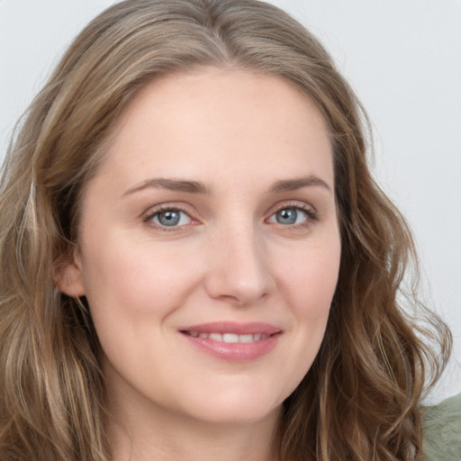 Joyful white young-adult female with long  brown hair and green eyes