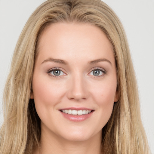 Joyful white young-adult female with long  brown hair and blue eyes