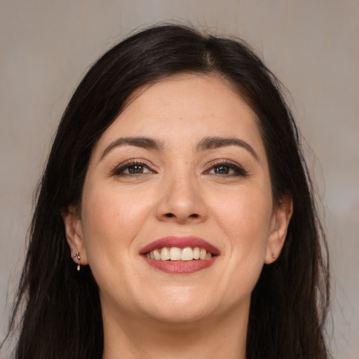 Joyful white young-adult female with long  brown hair and brown eyes