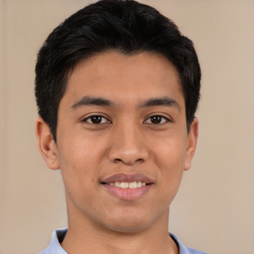Joyful latino young-adult male with short  black hair and brown eyes