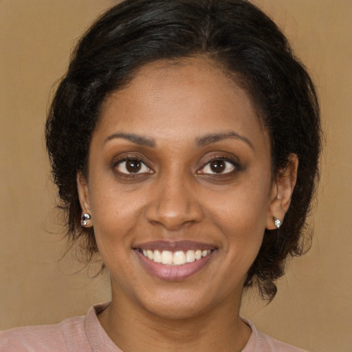 Joyful latino young-adult female with medium  brown hair and brown eyes