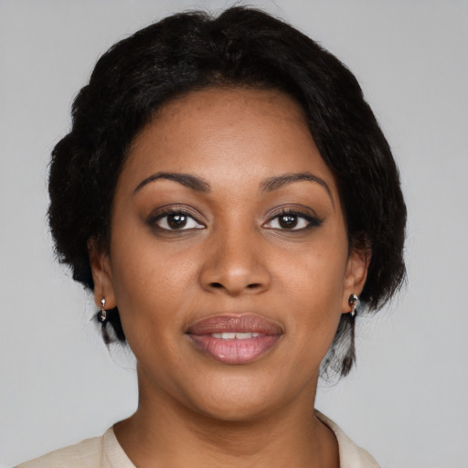 Joyful black young-adult female with medium  black hair and brown eyes