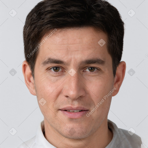 Joyful white adult male with short  brown hair and brown eyes