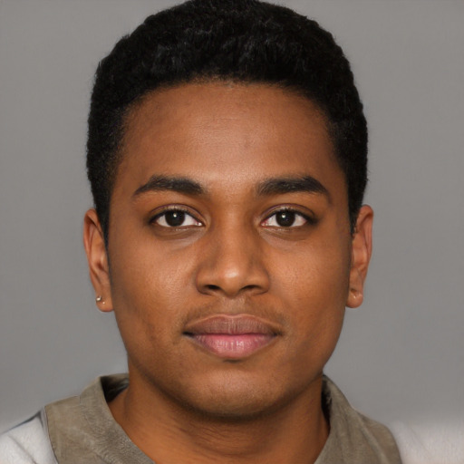 Joyful black young-adult male with short  black hair and brown eyes