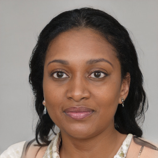 Joyful black young-adult female with medium  black hair and brown eyes