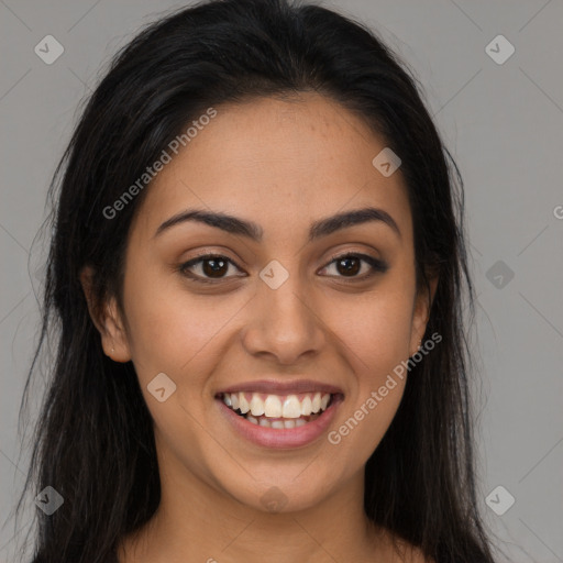 Joyful latino young-adult female with long  brown hair and brown eyes