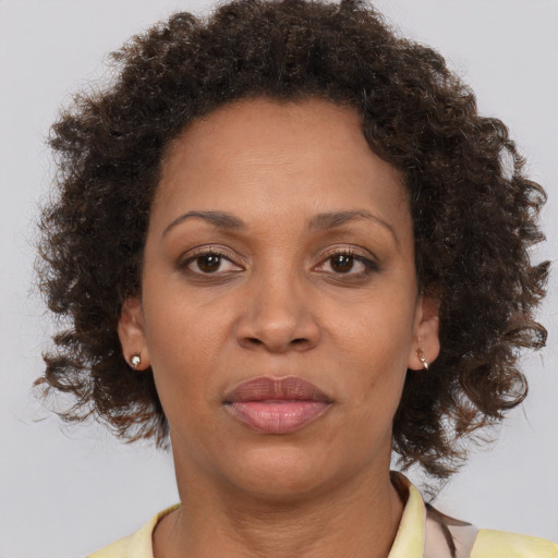 Joyful black adult female with short  brown hair and brown eyes