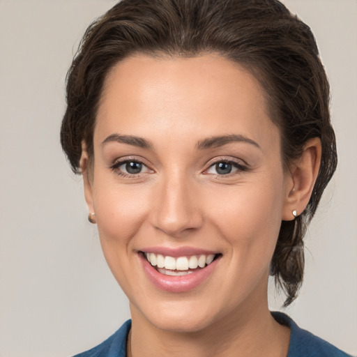 Joyful white young-adult female with medium  brown hair and brown eyes