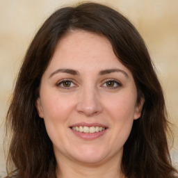 Joyful white adult female with long  brown hair and brown eyes