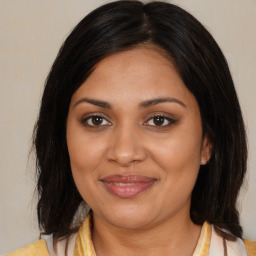 Joyful black young-adult female with medium  brown hair and brown eyes