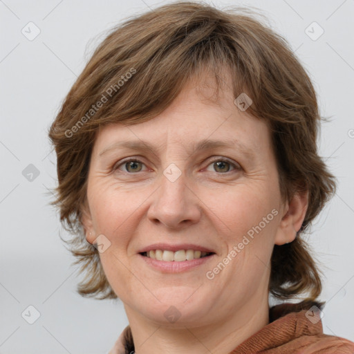 Joyful white adult female with medium  brown hair and grey eyes