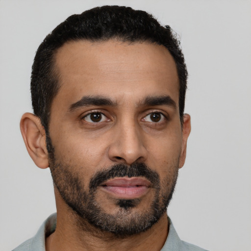 Neutral latino young-adult male with short  black hair and brown eyes