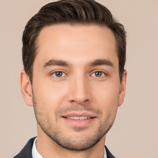 Joyful white young-adult male with short  brown hair and brown eyes