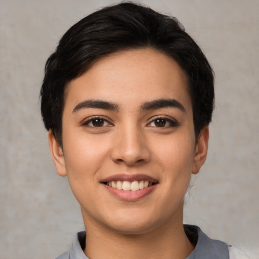Joyful white young-adult female with short  black hair and brown eyes