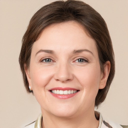 Joyful white young-adult female with medium  brown hair and grey eyes