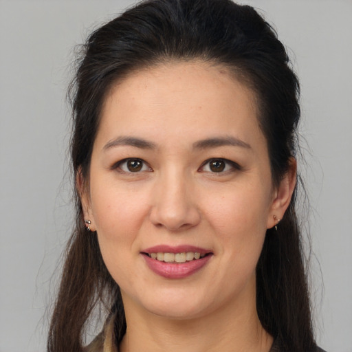 Joyful white young-adult female with long  brown hair and brown eyes