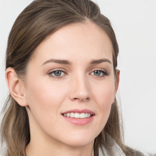 Joyful white young-adult female with long  brown hair and grey eyes