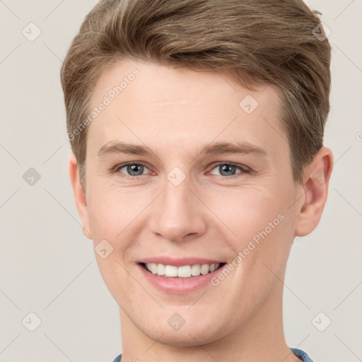 Joyful white young-adult male with short  brown hair and grey eyes