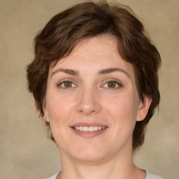 Joyful white young-adult female with medium  brown hair and green eyes