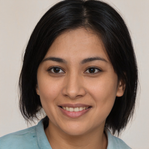 Joyful asian young-adult female with medium  brown hair and brown eyes