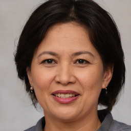 Joyful white adult female with medium  brown hair and brown eyes