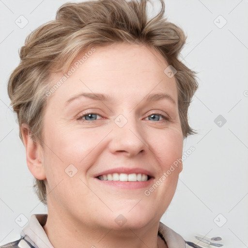 Joyful white adult female with short  brown hair and blue eyes