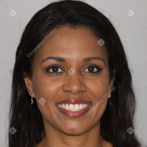 Joyful black young-adult female with long  brown hair and brown eyes