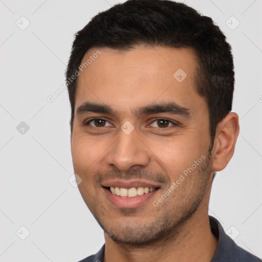 Joyful white young-adult male with short  black hair and brown eyes