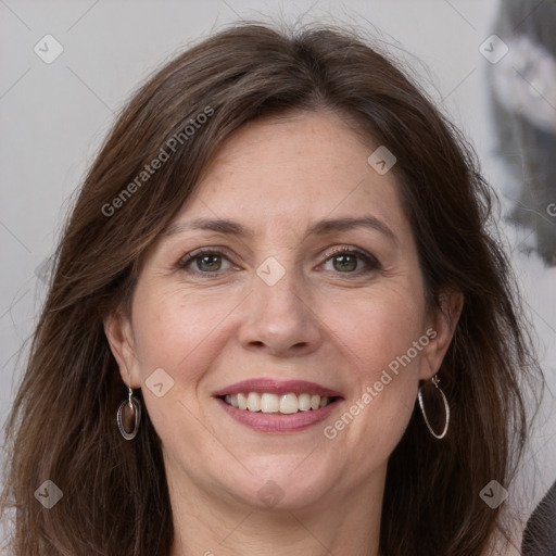 Joyful white adult female with long  brown hair and grey eyes