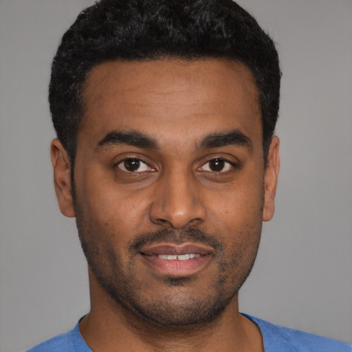 Joyful latino young-adult male with short  black hair and brown eyes