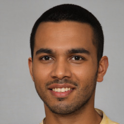 Joyful latino young-adult male with short  brown hair and brown eyes