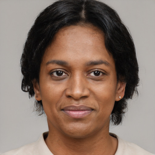 Joyful black adult female with medium  black hair and brown eyes