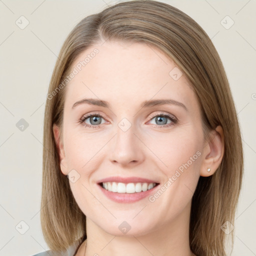 Joyful white young-adult female with medium  brown hair and blue eyes