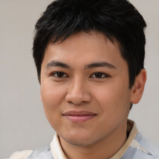 Joyful asian young-adult male with short  brown hair and brown eyes