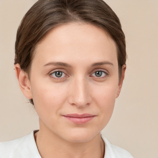 Joyful white young-adult female with short  brown hair and grey eyes