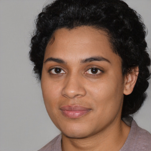 Joyful latino young-adult female with short  black hair and brown eyes