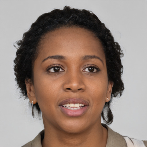 Joyful black young-adult female with medium  black hair and brown eyes