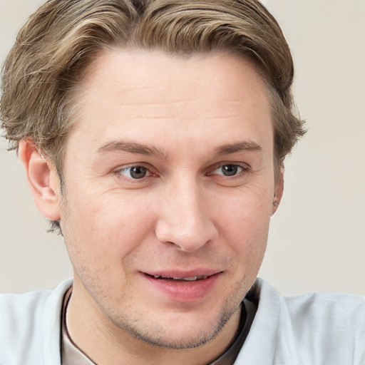 Joyful white adult male with short  brown hair and grey eyes