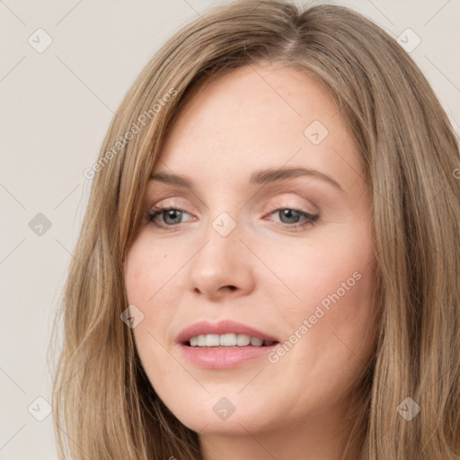 Joyful white young-adult female with long  brown hair and green eyes