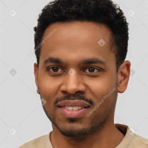 Joyful black young-adult male with short  black hair and brown eyes