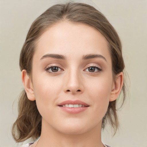 Joyful white young-adult female with medium  brown hair and green eyes