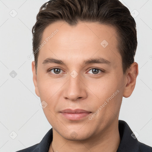 Joyful white young-adult male with short  brown hair and brown eyes